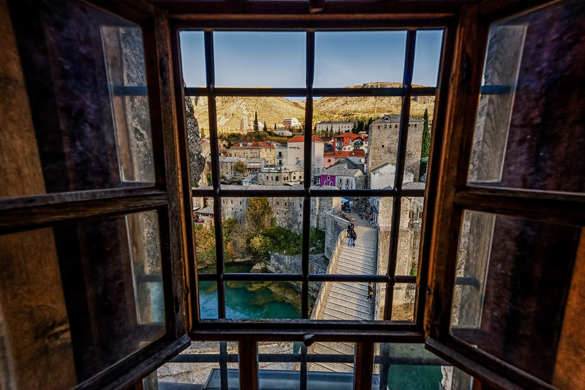 View of Stari Most in Mostar through an open wooden window